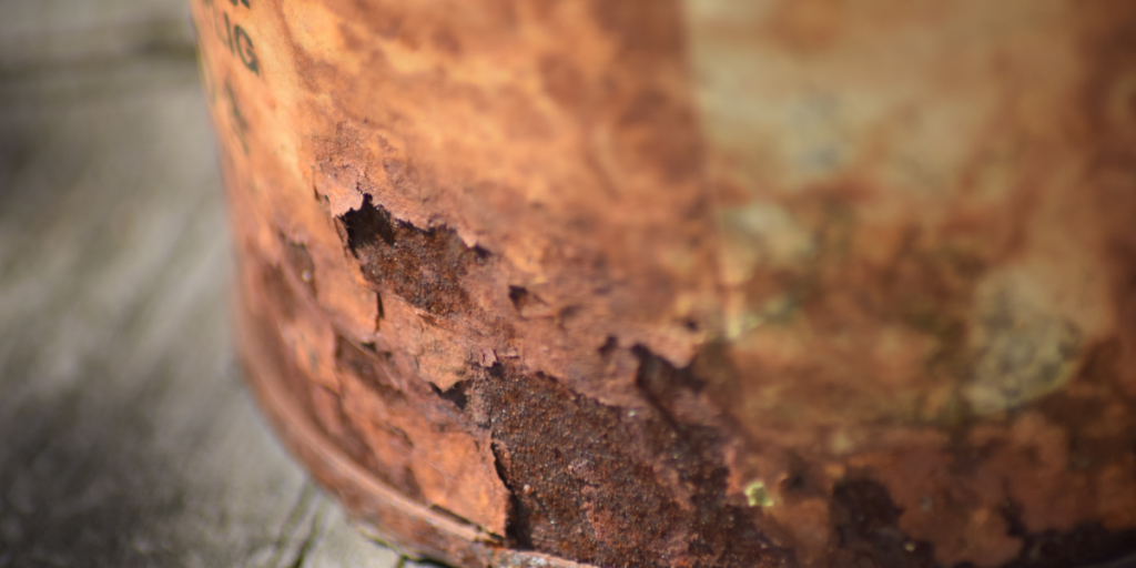 Detailed view of rust forming on metal components, reinforcing the need to prevent rust through proper care for air conditioning Gold Coast units.