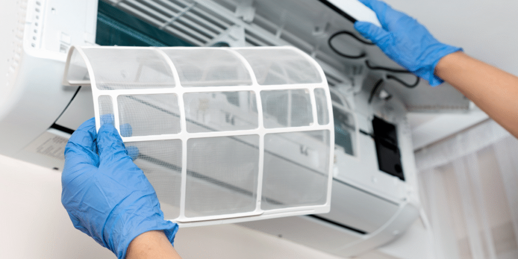 Preventative maintenance before Christmas & New Year for residential air conditioning Gold Coast, showing professional filter cleaning to improve airflow and efficiency.