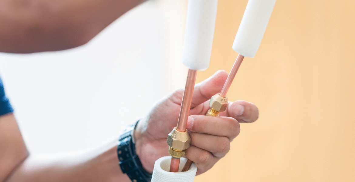 Close-up of a specialist repairing and replacing your AC copper pipes to ensure safe and efficient air conditioning Gold Coast operation.