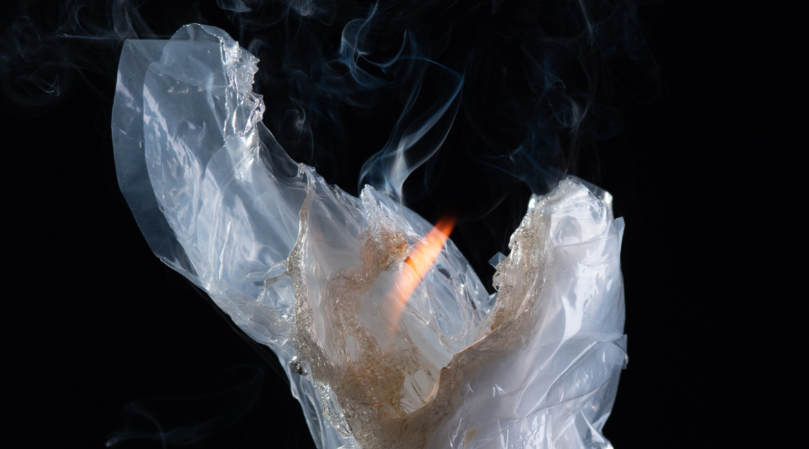 Close-up of melting and burning plastic with visible smoke and flame, representing the dangers of burning plastic fumes that may occur in faulty residential and commercial air conditioning Gold Coast systems.