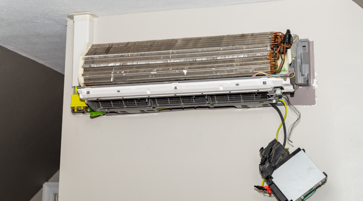 Black dust buildup inside an air conditioner unit, showing dirty coils that can cause black dust coming out of your air conditioner vent in residential air conditioning Gold Coast homes.