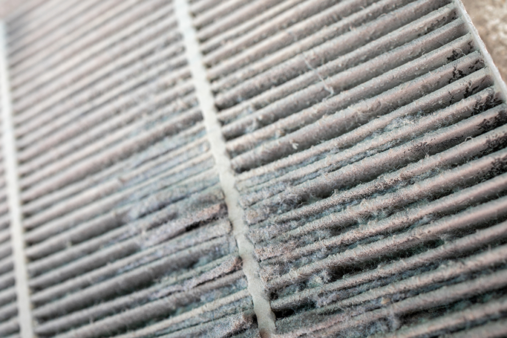 Dirty air filter clogged with dust and debris, a common cause of dirty sock syndrome in residential air conditioning Gold Coast.