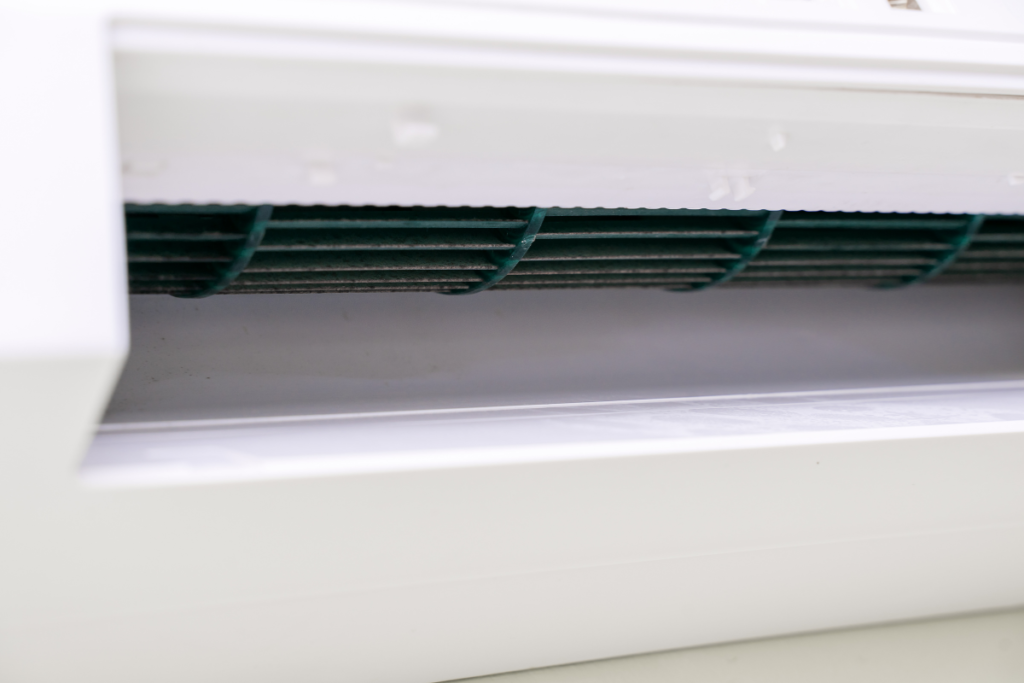 Close-up of contaminated evaporator coil and vents causing unpleasant smells.