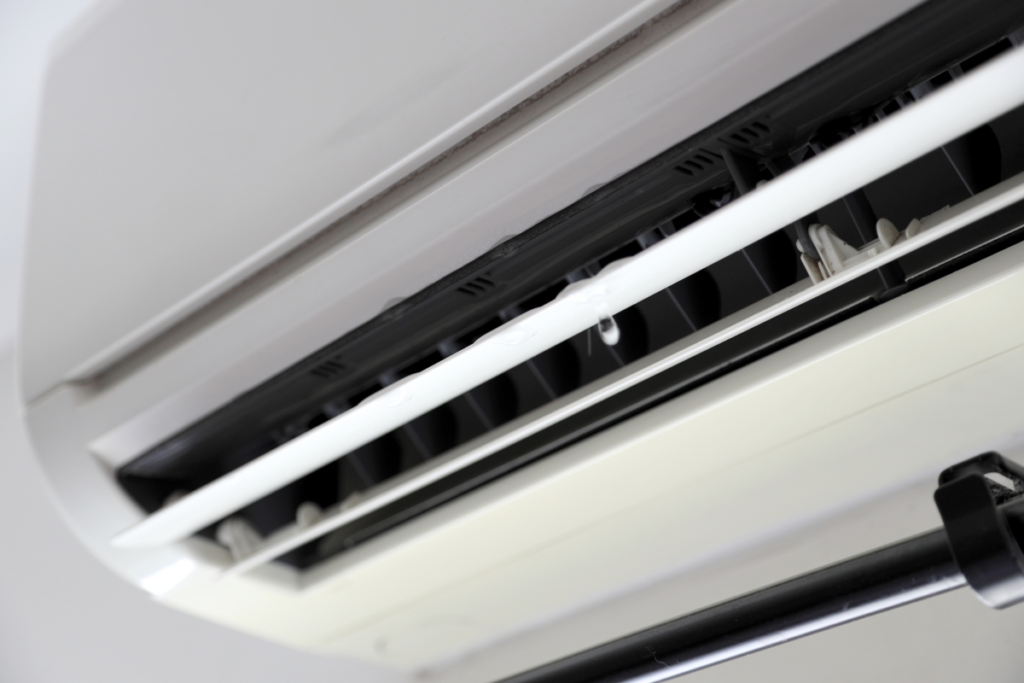 Air conditioner leaking water on rainy day from indoor unit, highlighting drainage problems in air conditioning Gold Coast homes and commercial spaces.