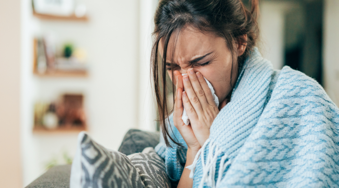 The woman wearing a blue blanket is having sick building syndrome. This is a syndrome that the owner of residential and commercial air conditioning has