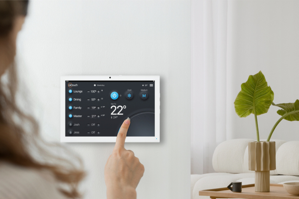 Wall-mounted smart control manage heatwaves by optimising air conditioning settings for comfort and energy savings in commercial air conditioning Gold Coast and residential spaces.