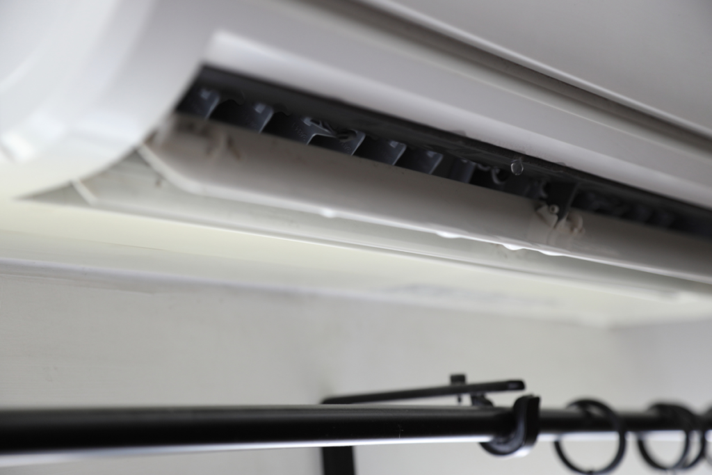 Still leaking water after cleaning from a wall-mounted air conditioner, showing moisture buildup inside residential air conditioning Gold Coast units.