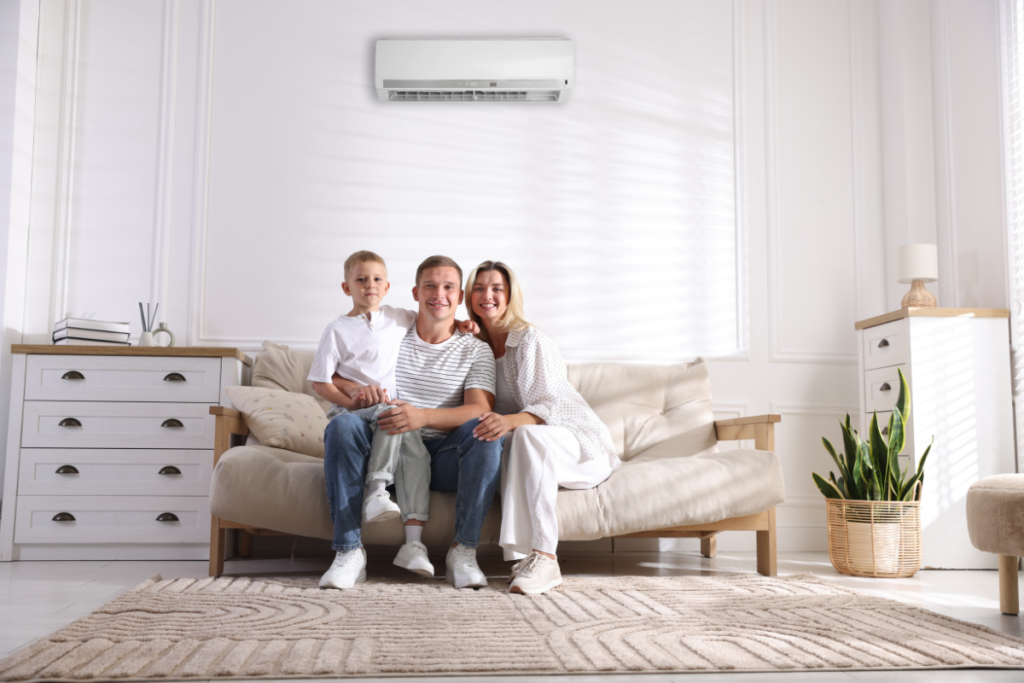 Family relaxing under split system to use air conditioning efficiently in autumn, showing how to use air conditioning in autumn to stay comfortable and save energy in air conditioning Gold Coast homes.