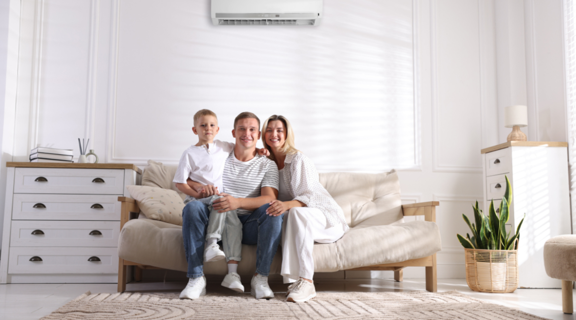 Family relaxing under split system to use air conditioning efficiently in autumn, showing how to use air conditioning in autumn to stay comfortable and save energy in air conditioning Gold Coast homes.