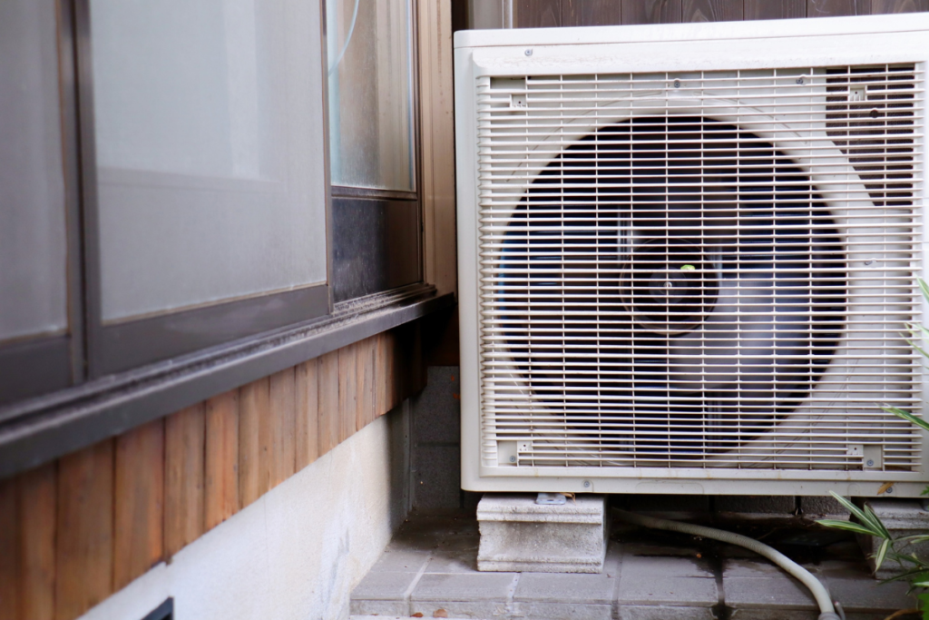Residential outdoor AC unit operating less efficiently, illustrating air conditioner feels weaker after peak summer, residential air conditioning Gold Coast.