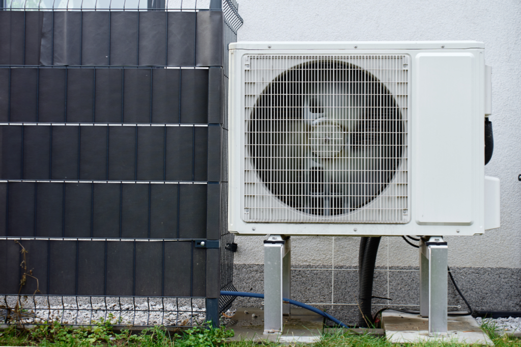 Outdoor condenser unit exposed to sun and weather, key factors to consider before replacing air conditioners in extreme heat on the Gold Coast.