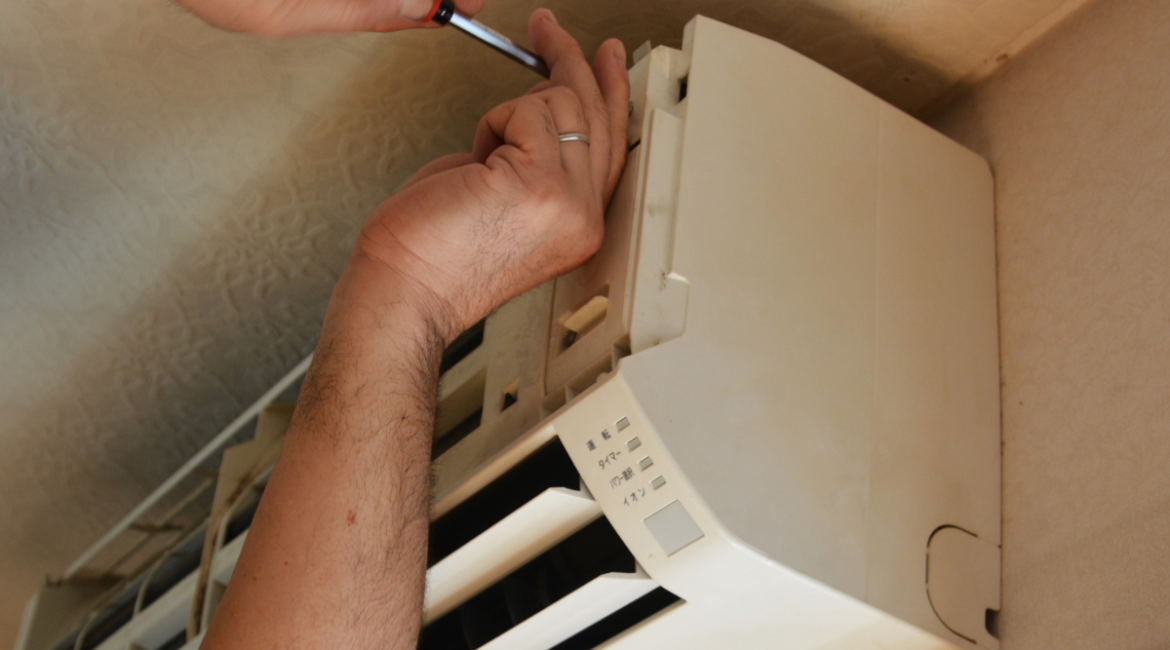 Professional checking internal components before recommending to replace your air conditioner, residential air conditioning Gold Coast upgrade project.