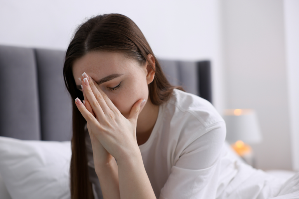Woman feeling uncomfortable and stuffier in early autumn, wondering what causes a house to feel stuffy despite mild weather in air conditioning Gold Coast home.