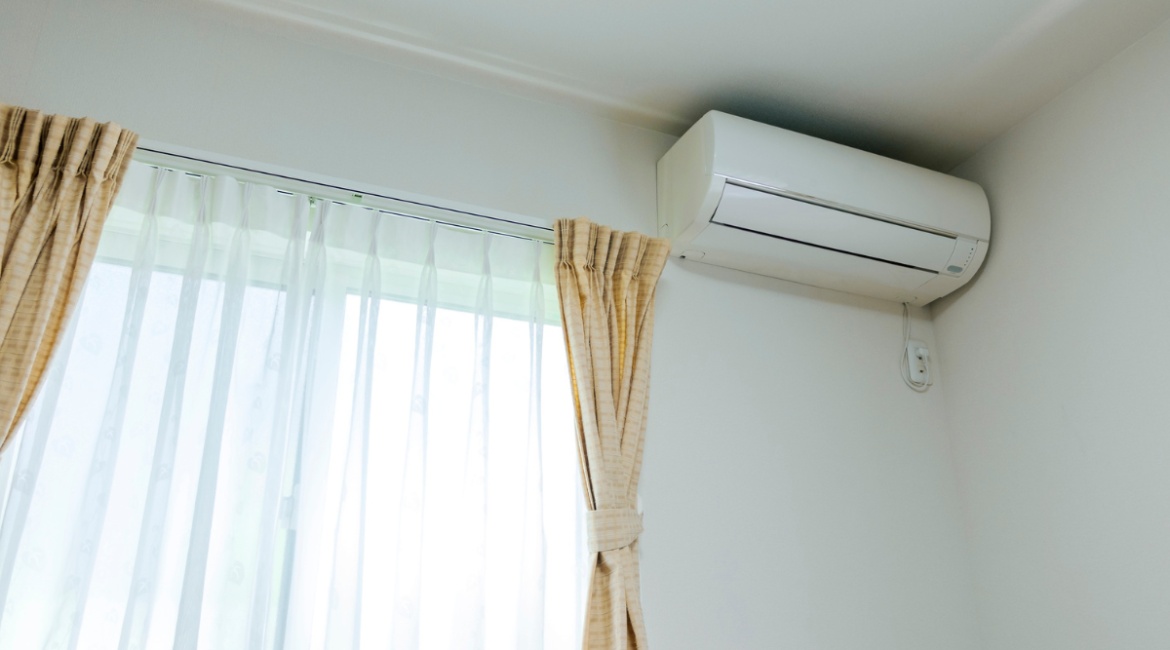 Wall mounted split system above window demonstrating summer AC settings and airflow adjustments.