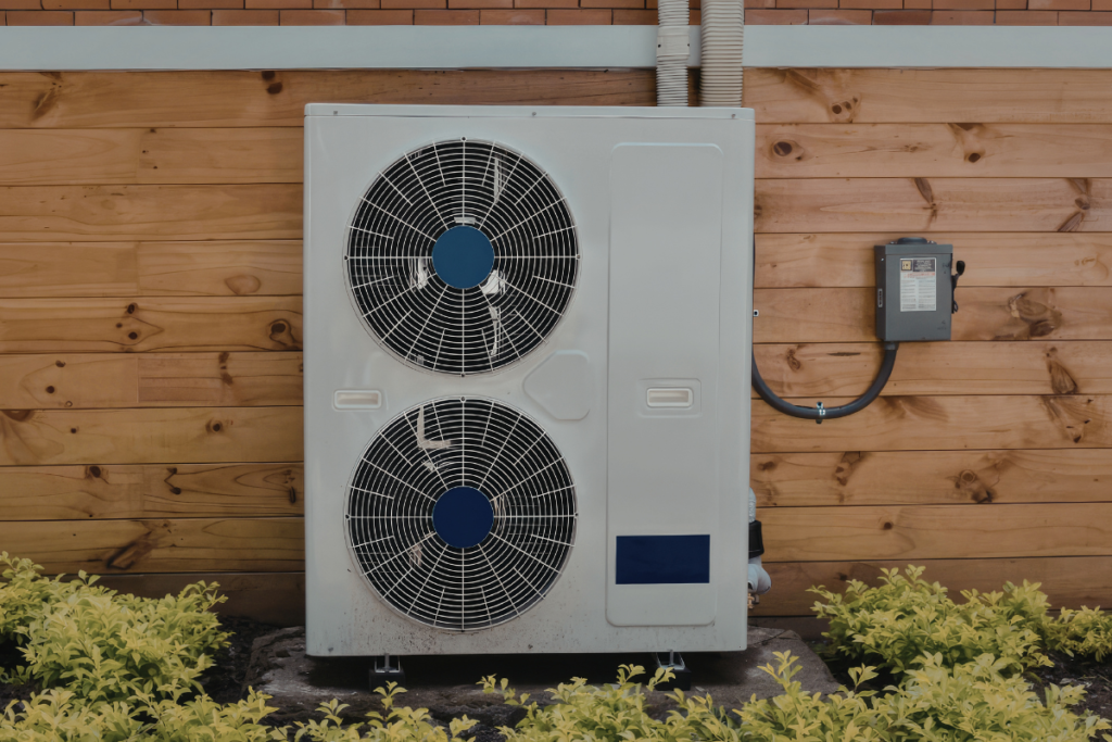 Turning off air conditioner outdoor unit on house wall before fall shutdown, routine check for air conditioner Gold Coast homes.