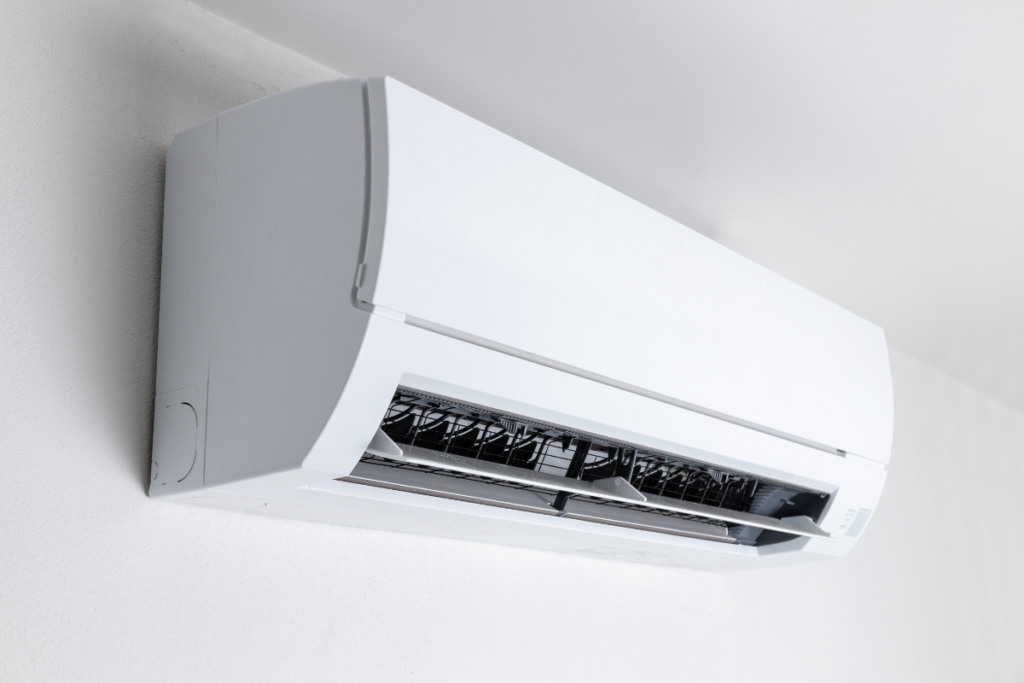 Close-up of a modern, white indoor residential air conditioning Gold Coast unit with open vents, perfect for those who use a dehumidifier to reduce the cooling load.