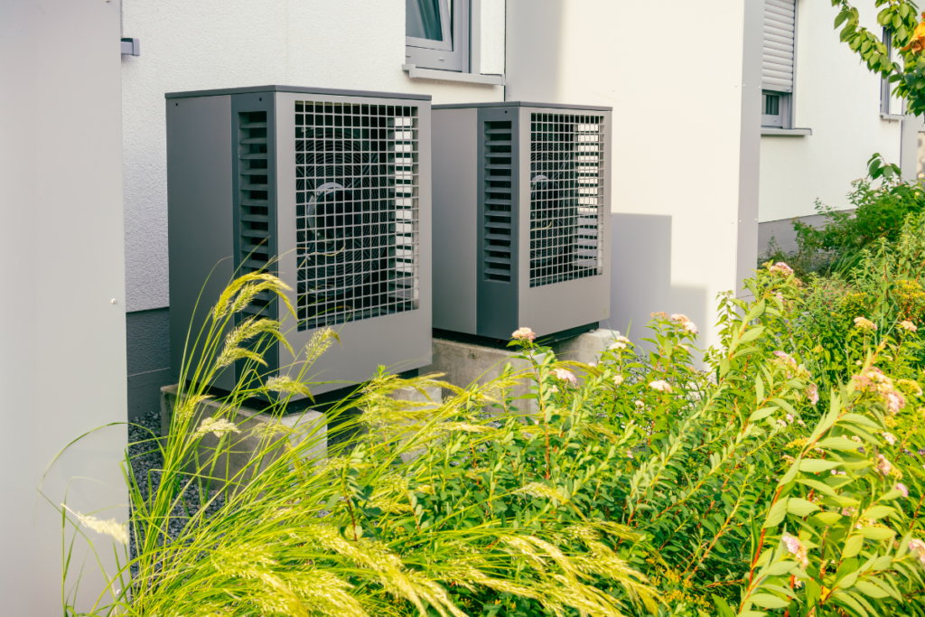 Dual anthracite grey heat pumps representing the latest in commercial air conditioning Gold Coast standards, integrated with smart home climate control for maximum energy efficiency