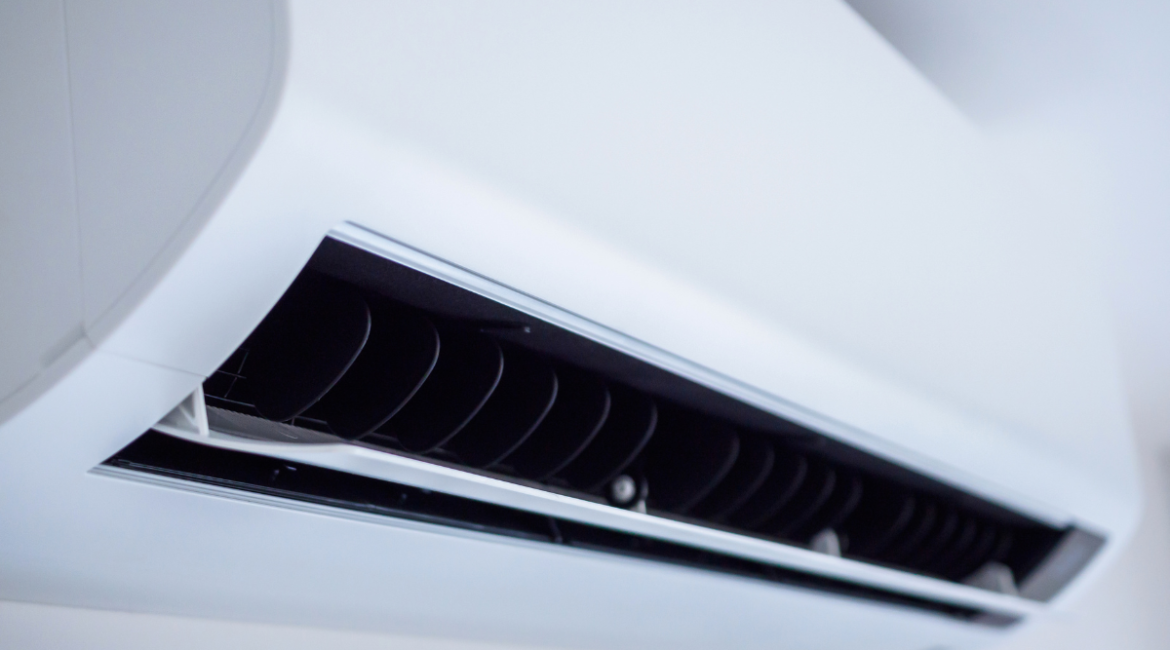 Close-up view of the fine, open ventilation fins on a modern, white wall-mounted air conditioning unit. Highlighting the detail of a clean unit, relevant for discussing optimal performance and avoiding issues that lead people to place a bowl of water in an AC room in a residential air conditioning gold coast setting.