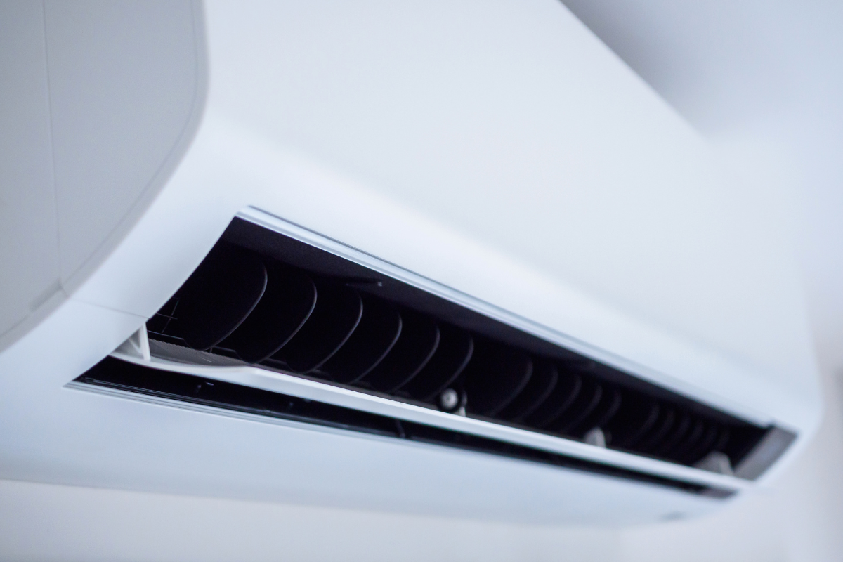 Close-up view of the fine, open ventilation fins on a modern, white wall-mounted air conditioning unit. Highlighting the detail of a clean unit, relevant for discussing optimal performance and avoiding issues that lead people to place a bowl of water in an AC room in a residential air conditioning gold coast setting.