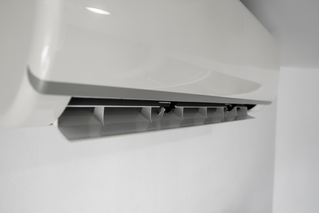 Close-up of open louvers on a sleek wall unit, showing where airflow exits when the aircon dehumidify setting is active in your air conditioning Gold Coast system.