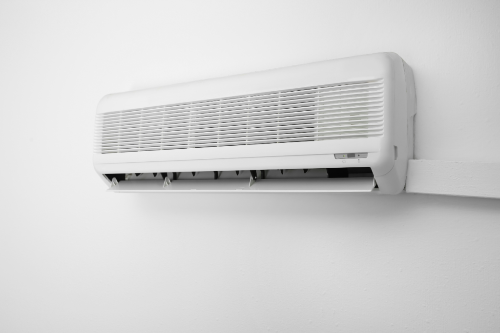 A modern white split-system unit on a wall, utilizing the aircon dehumidify mode for optimal air conditioning Gold Coast comfort.