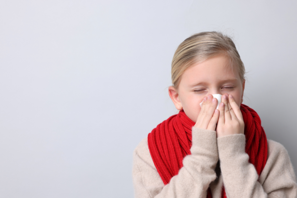A young girl struggling with nasal congestion. Parents often ask: Can AC cause nasal congestion in babies? Maintaining proper residential air conditioning gold coast settings is key to prevent drying out airways.