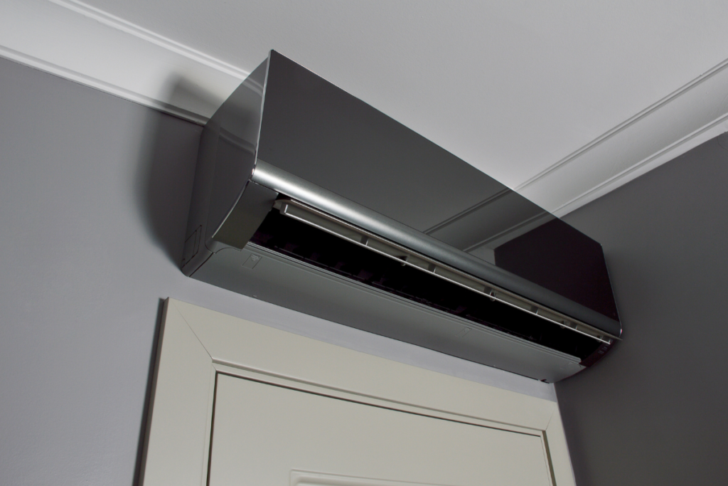 Modern dark-finish LG DualCool AI air conditioner installed in a stylish room, showcasing premium energy-efficient cooling and design for air conditioning Gold Coast homes.