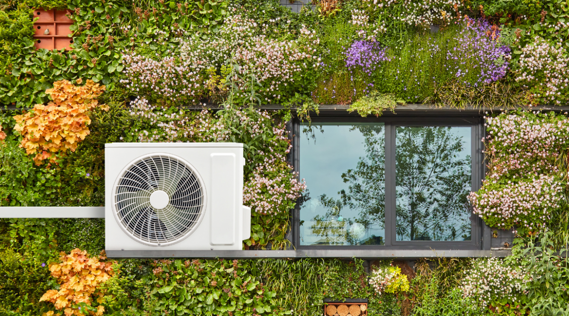 An outdoor compressor unit mounted on a lush vertical garden, perfectly illustrating sustainable cooling solutions and Panasonic ECO AI efficiency for commercial air conditioning Gold Coast.
