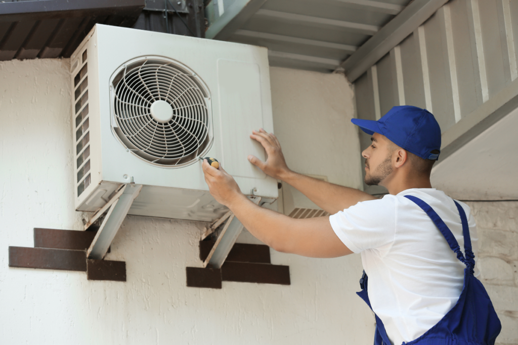 Technician performing outdoor service to maintain your AC system for residential air conditioning Gold Coast homes