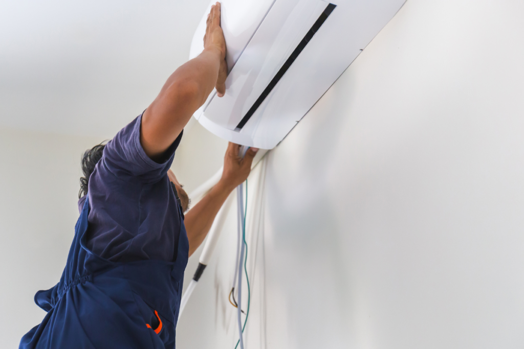 A technician performs an installation as part of a comprehensive air conditioning maintenance gold coast plan to ensure optimal temperature for whole house.