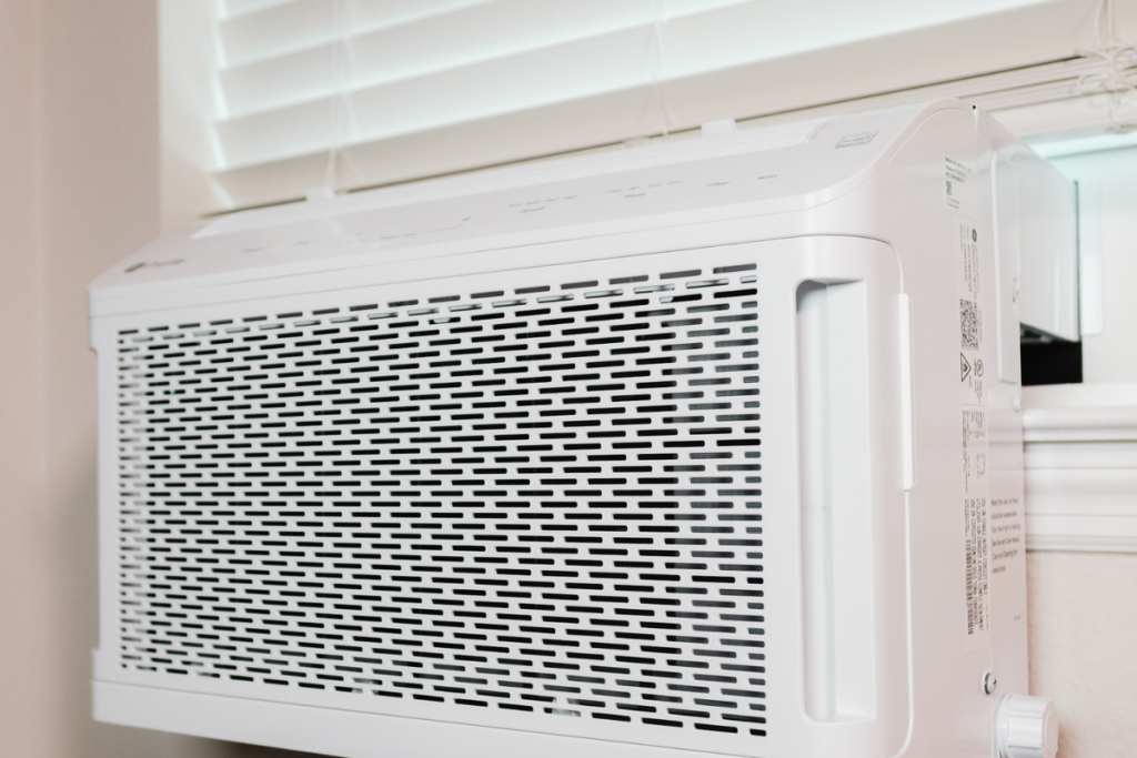 A sleek, modern white residential air conditioning gold coast window unit, which requires consistent air conditioning maintenance gold coast to prevent issues like blowing white steam or moisture buildup.