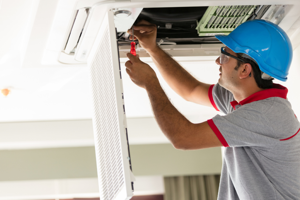 Expert technician conducting hotel HVAC maintenance and ceiling cassette service, supported by a GENERAL Fujitsu authorised dealer.