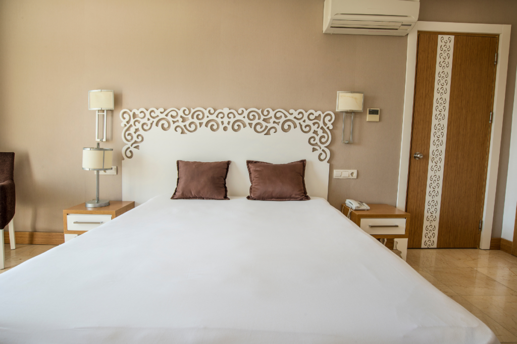 Hotel expansion air conditioning installation with a wall-mounted split unit above the doorway in a new guest room