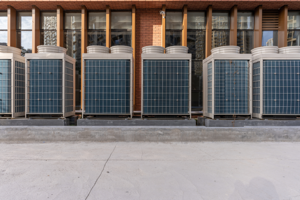 Hotel HVAC maintenance on a row of outdoor condenser units supporting a hotel expansion air conditioning system