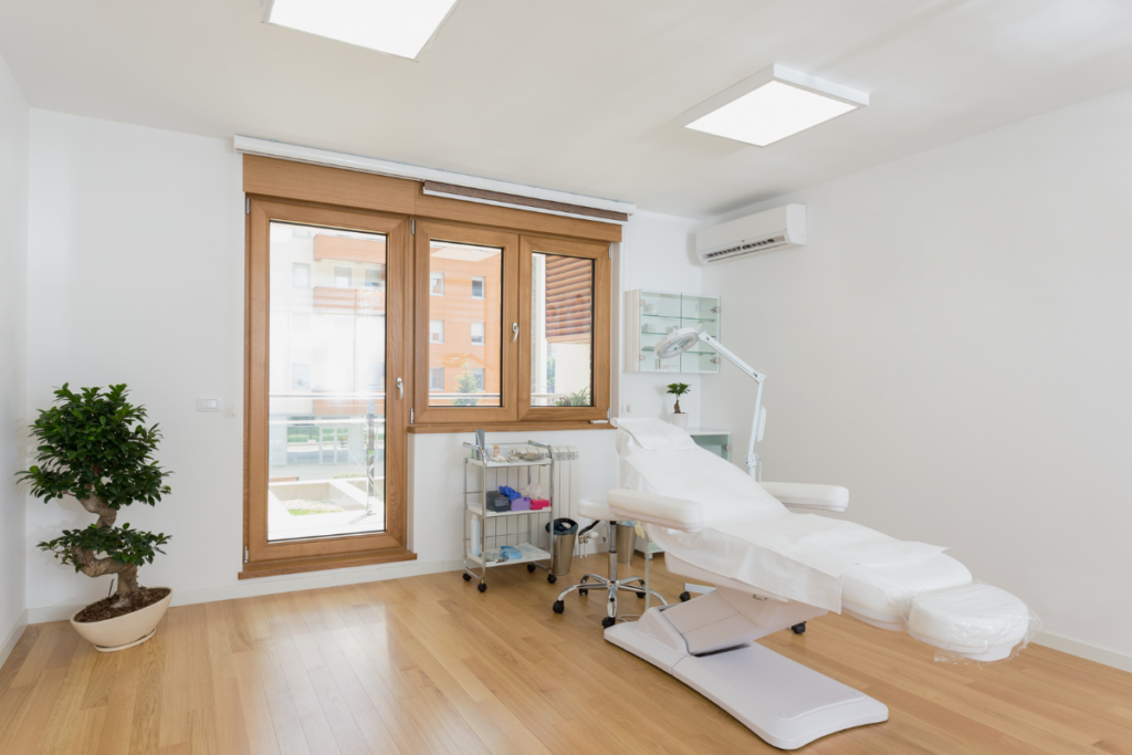 A clean, professional treatment room with a wall-mounted unit highlighting quality new medical practice air conditioning installation and specialized healthcare HVAC installation design.