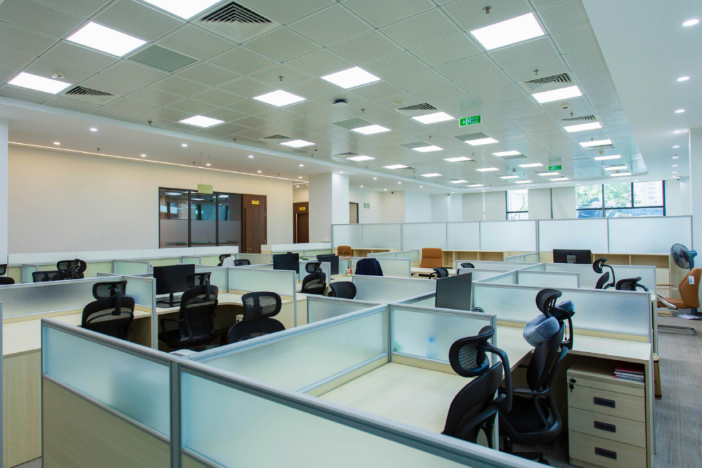 A large-scale corporate cubicle office with a grid tile ceiling showing integrated air conditioning vents, ideal for a complete office air conditioning installation eofy tax deduction.