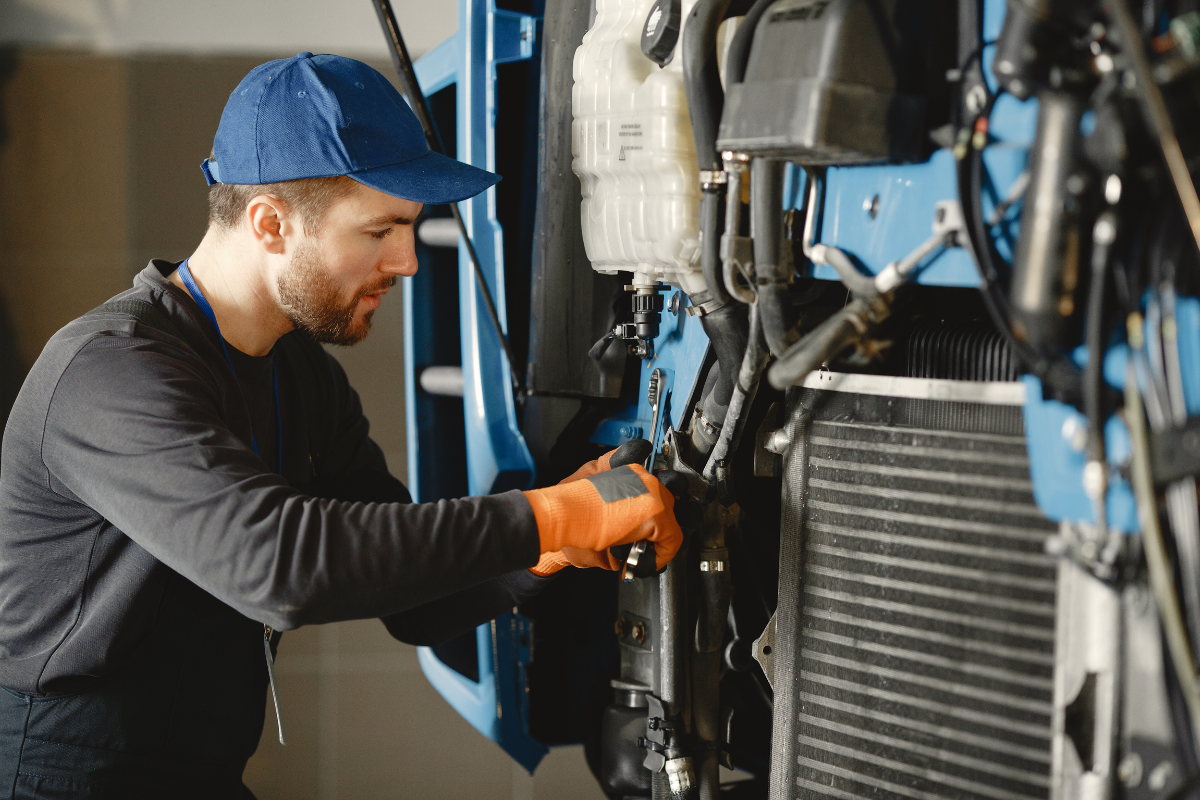 Mechanical technician using a wrench to repair a heavy-duty cooling coil during commercial air conditioning repair Gold Coast.
