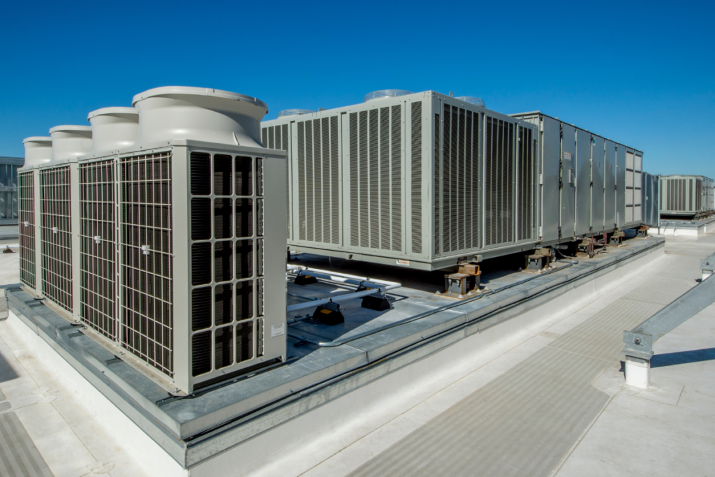 Row of heavy-duty rooftop package units that rely on professional hotel air conditioning service for energy efficiency.