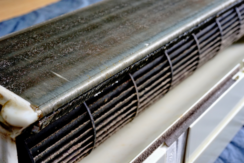 Dirty evaporator coil before winter hydro clean treatment, highlighting the need for AC mould removal Gold Coast and commercial air conditioning cleaning Gold Coast to maintain hotel indoor air quality.