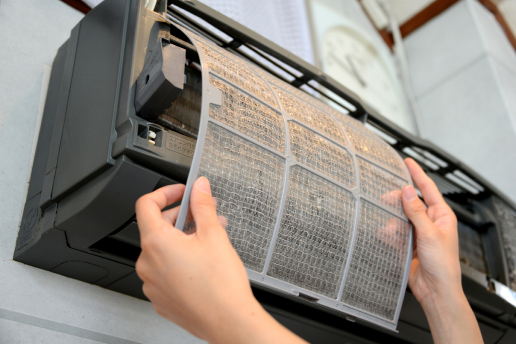 Air filter removal during a winter hydro clean service, part of a hydro clean air conditioner process that enhances hotel indoor air quality and supports commercial air conditioning cleaning Gold Coast.