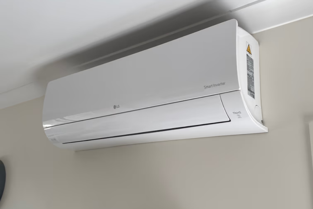 Angled view of an LG ThinQ Smart Inverter split system near the ceiling, showing why LG air conditioners are good for the home.