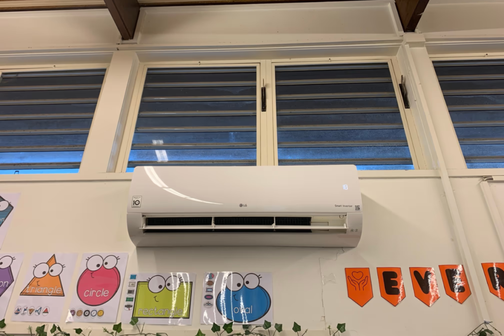 Wall-mounted LG Smart Inverter split system set high above the windows, an LG air conditioner Gold Coast rooms rely on.