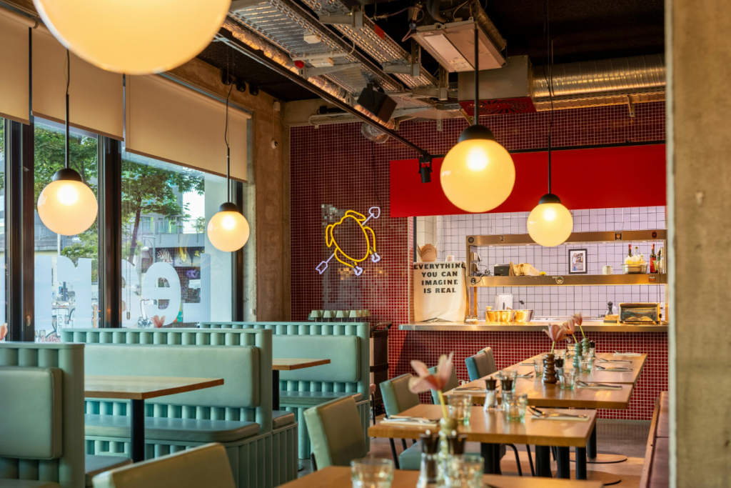 Air conditioning for restaurants and cafes on the Gold Coast: retro diner with an open kitchen, commercial kitchen cooling and ceiling ducting warming the dining room