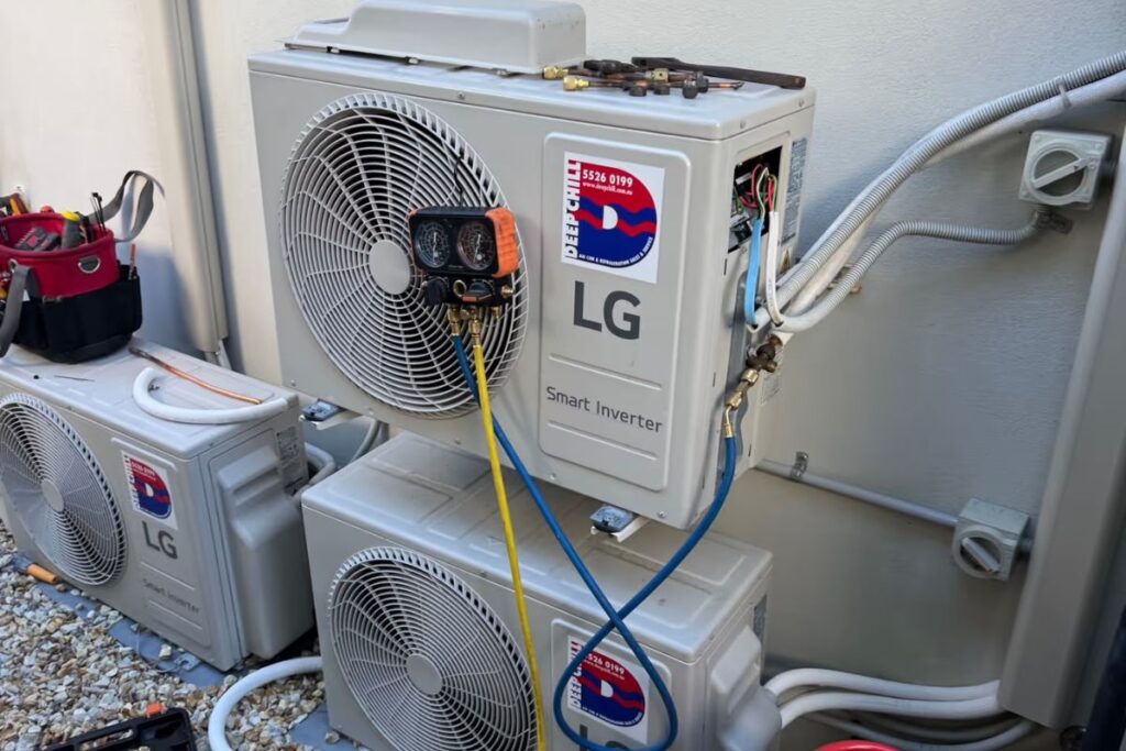 DEEPCHILL technician checking refrigerant charge on an LG air conditioner on the Gold Coast