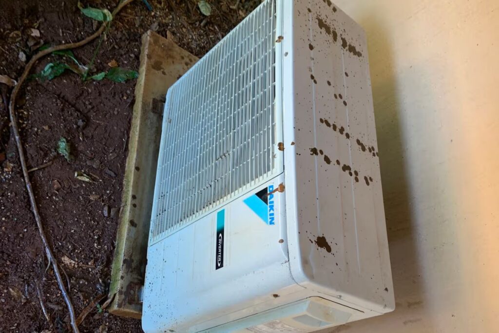 Old Daikin unit removed from the wall, a clear sign of when to replace an air conditioner