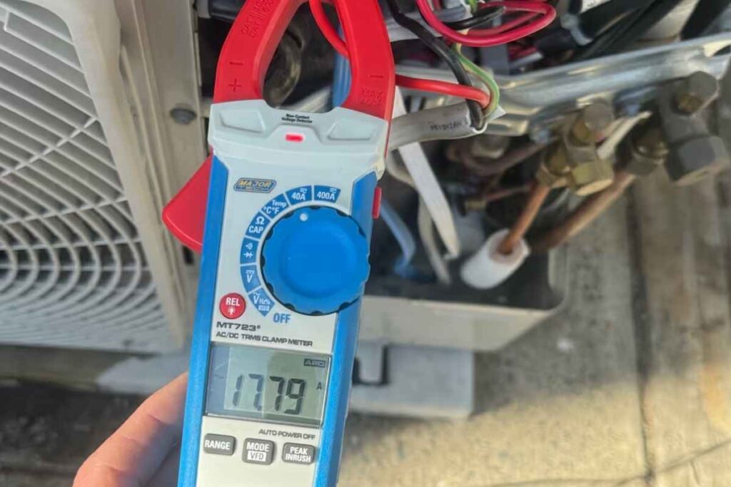 Clamp meter reading 17.79 amps at the outdoor unit during an air conditioning repair Gold Coast diagnosis