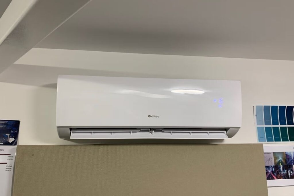 Gree wall-mounted split system running in heating mode during a Gold Coast winter, ready after an aircon service.