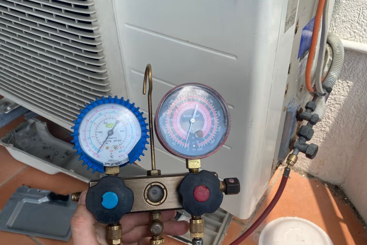 Manifold gauges on a Gold Coast outdoor unit checking an air conditioner not cooling before a gas recharge
