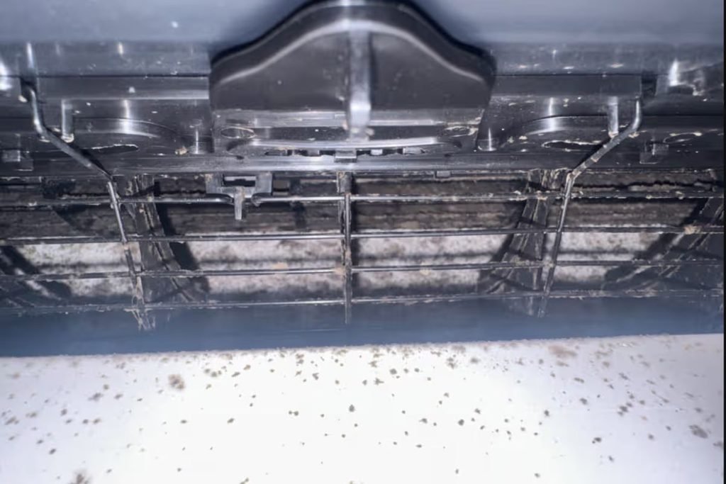 Dust and debris in a dirty air conditioner vent, a common air conditioner asthma allergies trigger