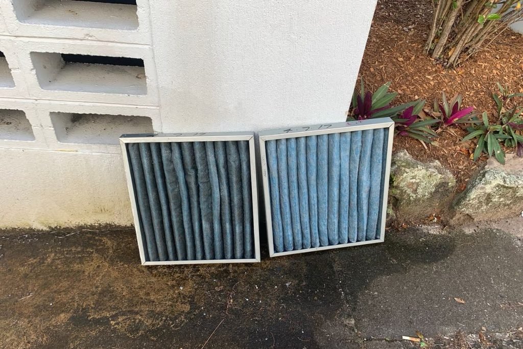 Air conditioner filter pollen and dust build-up on return air filters removed during a service